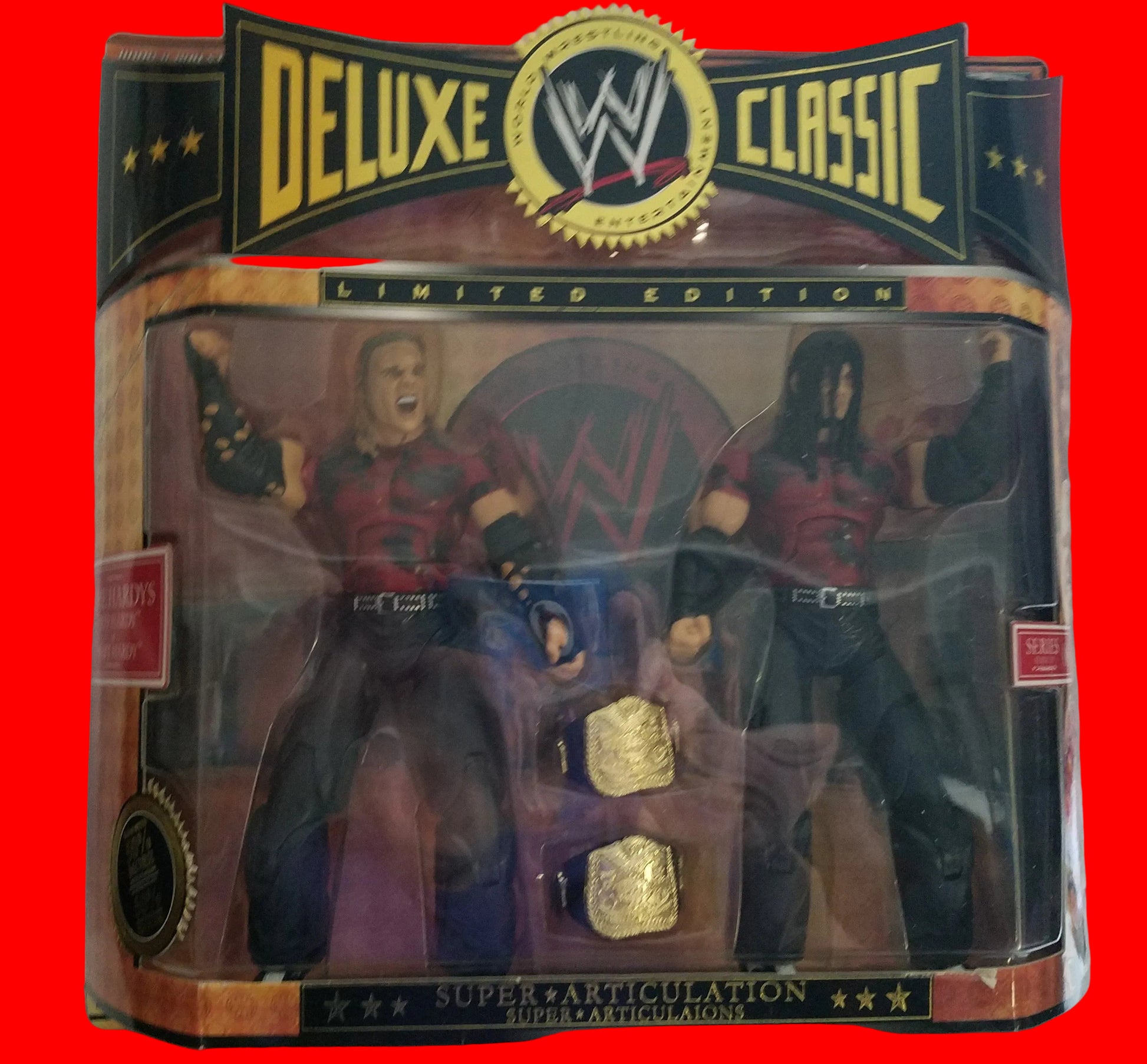 WWE Classic Deluxe Limited Edition Super Articulation double action figure set featuring two wrestlers in red and black outfits with gold championship belts inside the packaging.
